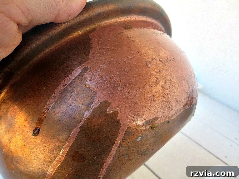 Copper Pot Upcycling Nightmares 6 Cleaning the vintage copper pot with a lemon and salt mixture, demonstrating its effectiveness