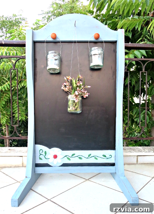 Vintage Chalkboard Stand Reimagined 2 Upcycled vintage chalkboard stand with blue paint and decorative flowers, perfect for outdoor balcony decor. www.theboondocksblog.com