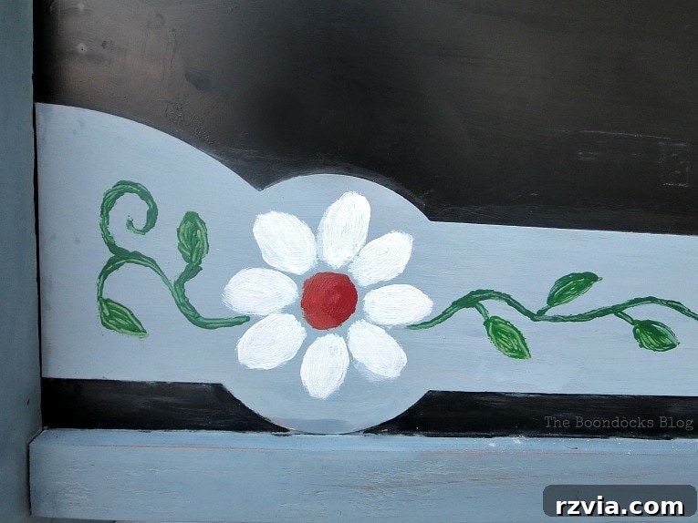 Vintage Chalkboard Stand Reimagined 11 Author's hand-painted flower design on the other side of the chalkboard stand, using acrylic craft paints for vibrant detail. How to Give New Life to a Chalkboard Stand www.theboondocksblog.com
