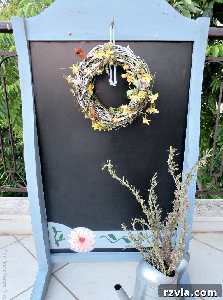 Vintage Chalkboard Stand Reimagined 16 The other side of the upcycled chalkboard stand, featuring a hanging wreath, highlighting its versatility in outdoor decor. How to Give New Life to a Chalkboard Stand www.theboondocksblog.com