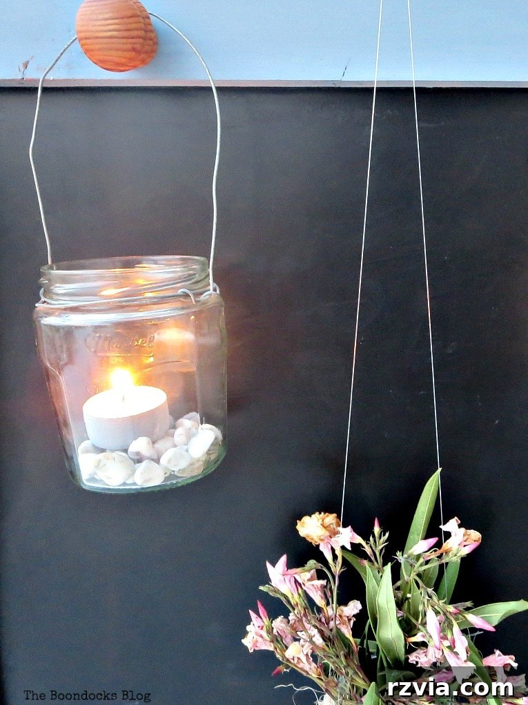 Vintage Chalkboard Stand Reimagined 18 Lit tea lights in lanterns hanging on the upcycled chalkboard stand, creating a warm evening ambiance on the balcony. How to Give New Life to a Chalkboard Stand www.theboondocksblog.com