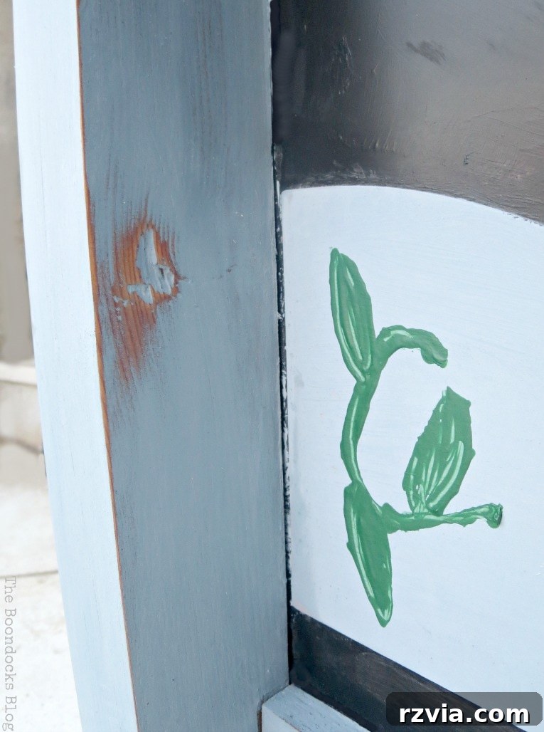 Vintage Chalkboard Stand Reimagined 9 Close-up detail of the distressed blue paint and smoothed finish on the vintage chalkboard stand, highlighting the rustic appeal. How to Give New Life to a Chalkboard Stand www.theboondocksblog.com
