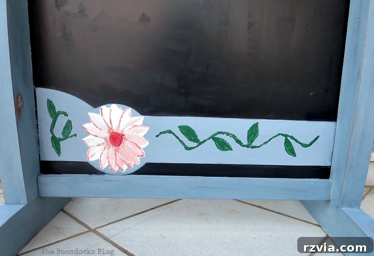 Vintage Chalkboard Stand Reimagined 10 Daughter's hand-painted white and red flower and vine design on the former orange plastic piece of the upcycled chalkboard stand. How to Give New Life to a Chalkboard Stand www.theboondocksblog.com