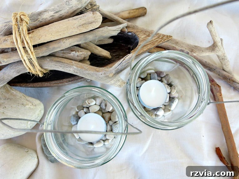 Transform Jars into Glowing Lanterns 2 Top view of beach-themed mason jar lanterns with driftwood and pebbles, perfect for easy craft and repurposed jar ideas, creating cozy tealight lanterns and DIY lantern lights from a simple wire project.