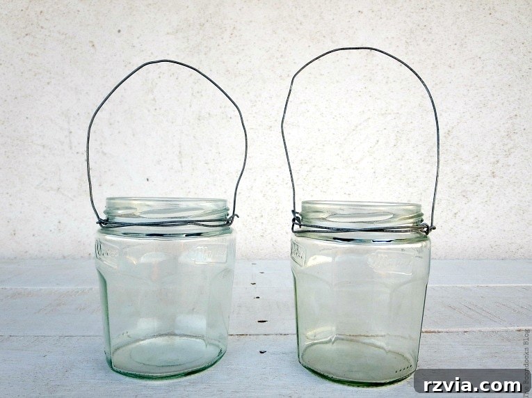 Transform Jars into Glowing Lanterns 13 Two completed wire-wrapped jar lanterns, showcasing the rustic and charming result of the DIY project with repurposed materials.
