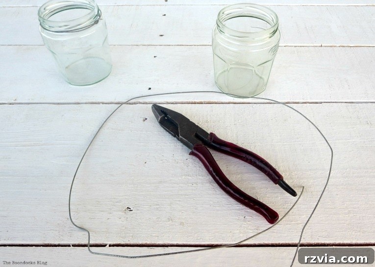 Transform Jars into Glowing Lanterns 4 Required materials for making simple DIY lanterns: glass jars, craft wire, and pliers, laid out for an easy and quick craft project.
