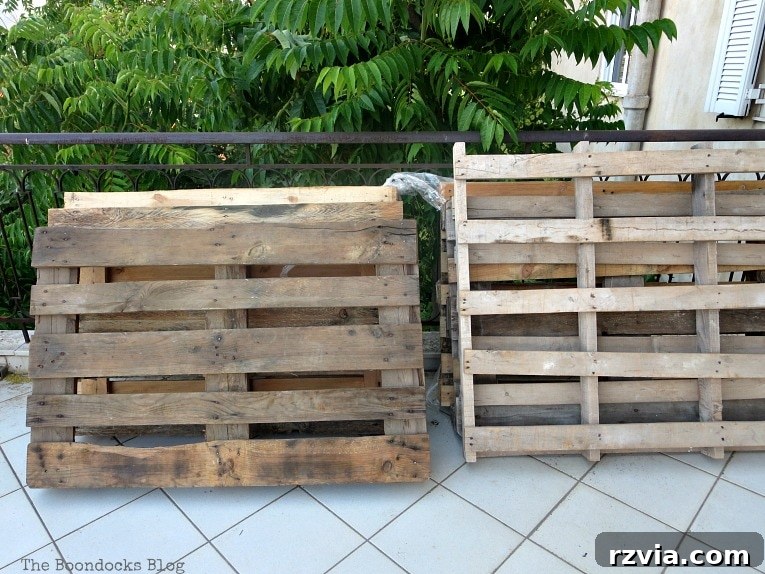 Super Simple Pallet Couch No Tools Needed 3 A stack of raw wooden pallets ready for transformation into a super easy DIY pallet couch.
