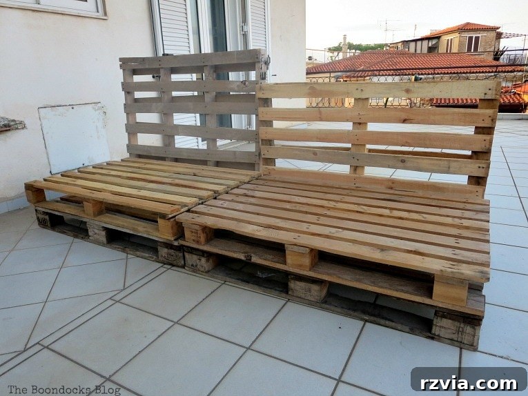 Super Simple Pallet Couch No Tools Needed 4 Pallets arranged to form the basic structure of a couch, demonstrating the initial placement of the base and backrest.
