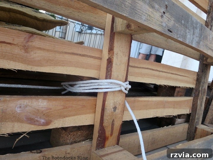 Super Simple Pallet Couch No Tools Needed 9 A detailed view of the securely tied backrest, showcasing the rope's role in forming a stable structure.