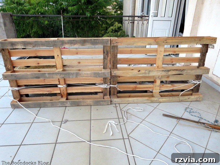 Super Simple Pallet Couch No Tools Needed 10 A rear view of the completed pallet couch structure, highlighting the secure rope ties that ensure stability.