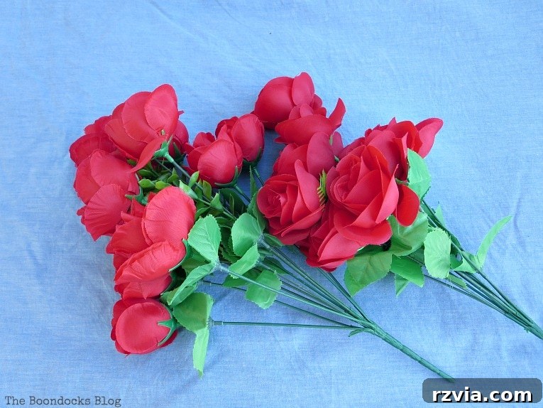 Budget Blooms: Brighten Your Fence 3 Two vibrant bouquets of artificial red roses, perfect for a budget-friendly DIY project.