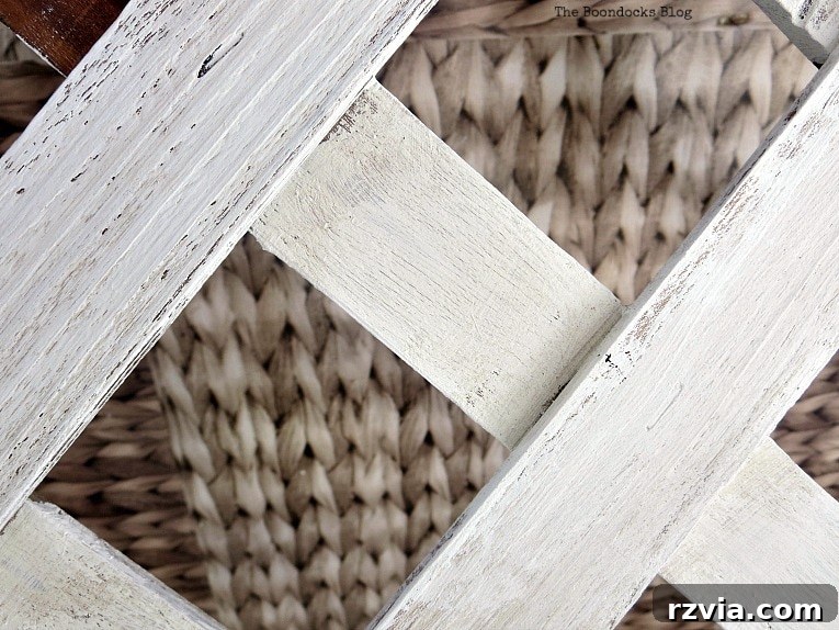 Budget Blooms: Brighten Your Fence 6 Artist's hands carefully painting the lattice strips with Old Fashioned Milk Paint in Oyster White for a weathered look.