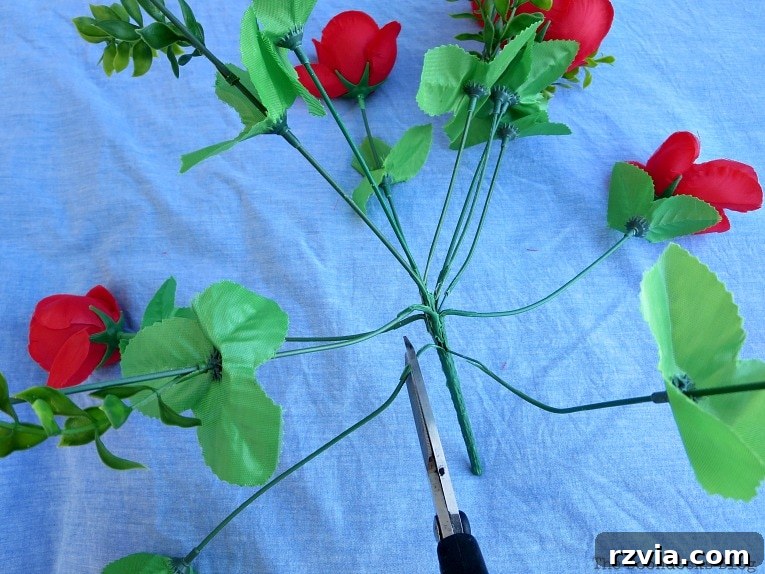 Budget Blooms: Brighten Your Fence 10 Hands carefully separating the individual flowers from a bouquet of artificial red roses using pliers.