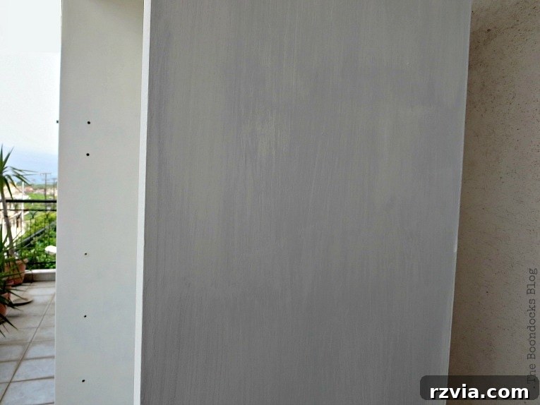 Upcycled Bookcases: Crafting Success, Avoiding Pitfalls 10 Applying the custom gray color to the exterior of the bookcase, adding a subtle, sophisticated touch.
