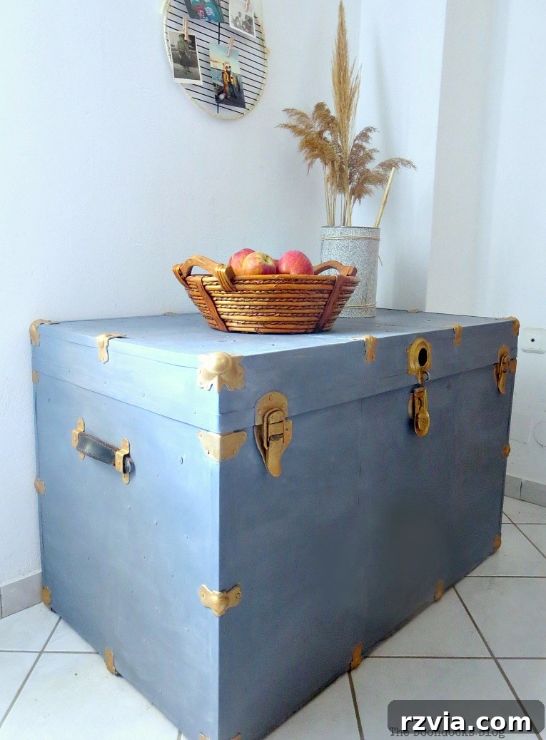 Aged to Perfection: Milk Painting a Vintage Metal Trunk 15 A beautifully painted vintage metal trunk, showcasing its new life as a decorative and functional storage piece in a home setting.
