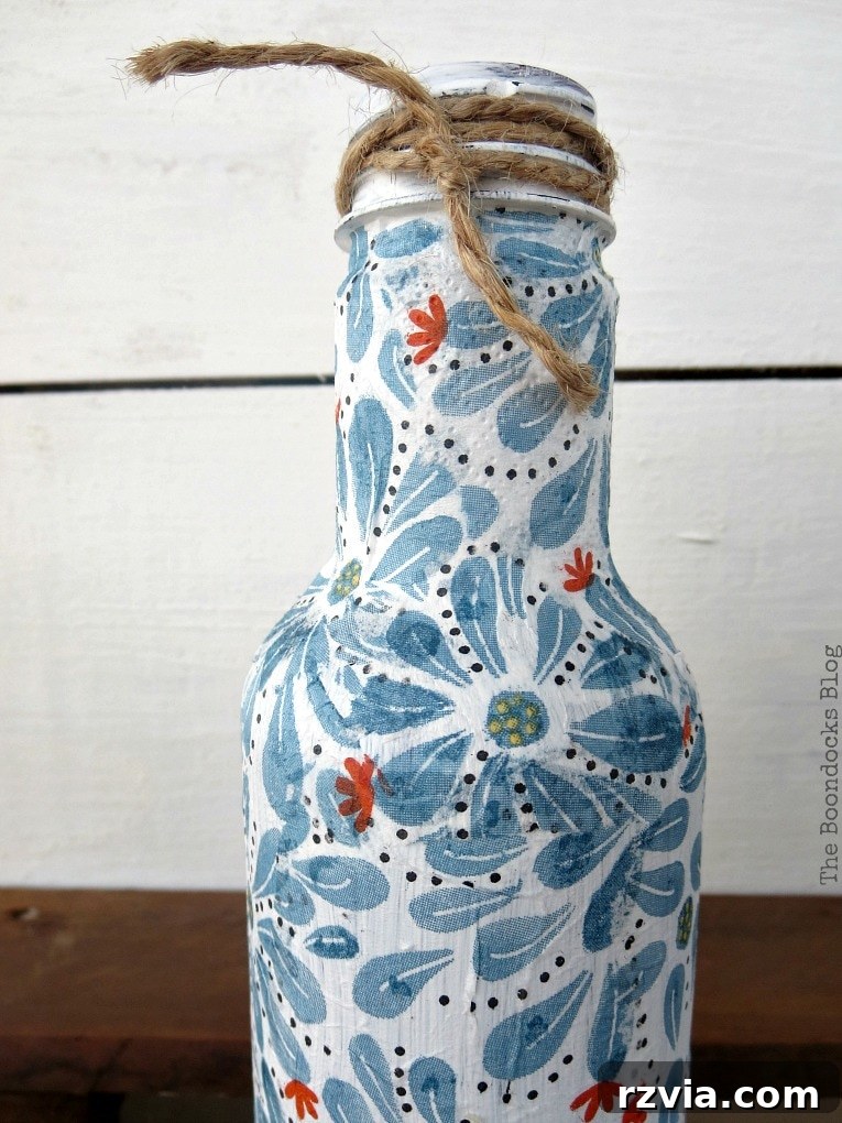 White decoupaged bottle, showcasing a successful outcome with a light primer.