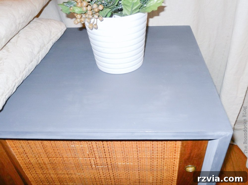 Milk Paint Revived Mid-Century Modern Sideboard 11 Side view of the revitalized Mid-Century Modern sideboard, showcasing the contrast between the new paint and original wood doors.