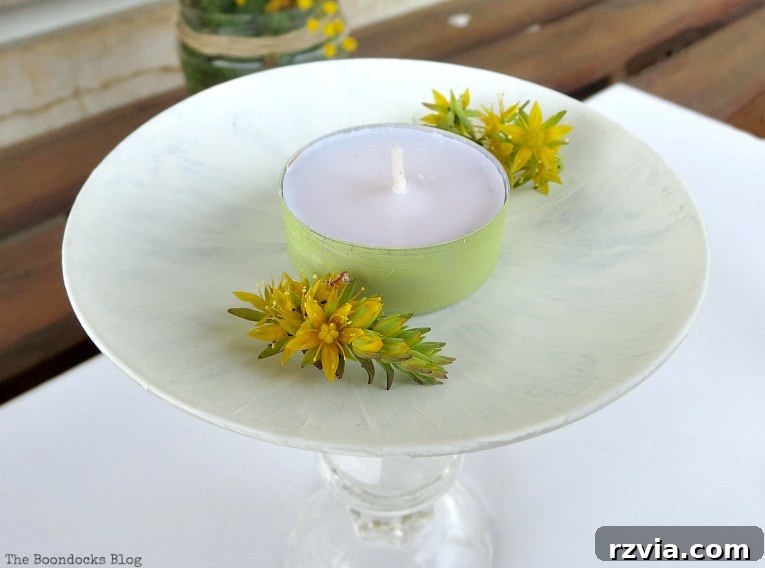 Sweet Spring Stages Repurposed Cordial Glasses 12 Painted tealight with yellow succulent flowers sitting on the painted saucer.