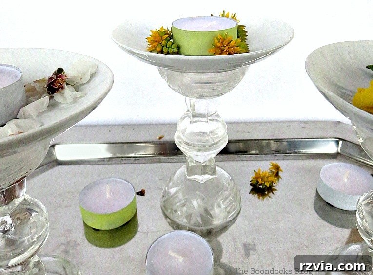 Sweet Spring Stages Repurposed Cordial Glasses 15 Pedestals placed on a silver tray with tea lights and flowers.