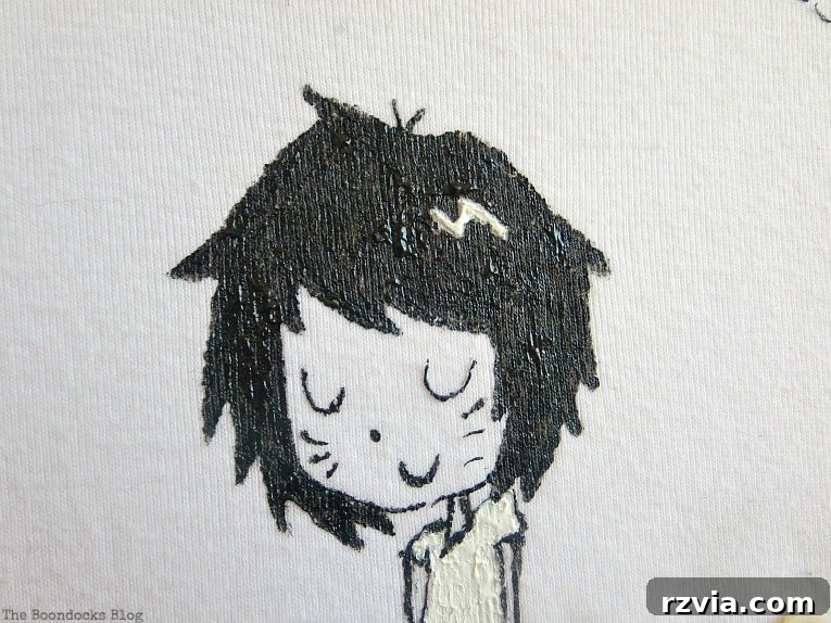 Upcycled T-shirt Wall Decor 4 Close up of a head of the character on a tshirt, highlighting the detailed illustration.