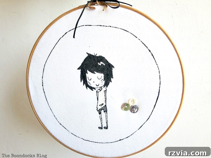 Upcycled T-shirt Wall Decor 7 Upcycled tshirt placed into the embroidery hoop and securely hung on the wall, showcasing the finished fabric art.