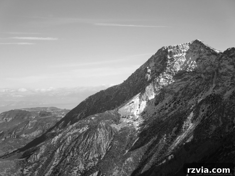 The White Crowns of Greece 15 Expansive mountain view captured during winter in Greece, showcasing the vastness and beauty of the snowy landscape.