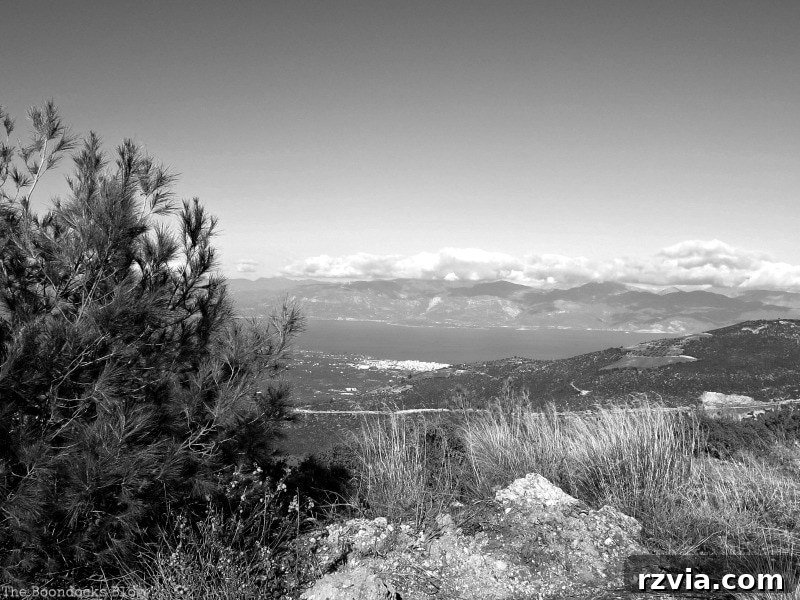 The White Crowns of Greece 4 Dramatic black and white photograph looking down to a snow-covered valley in the Greek mountains, emphasizing stark contrasts and textures, inspired by Ansel Adams.