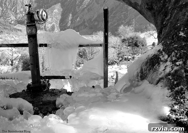 The White Crowns of Greece 9 A frozen water faucet in the snowy Greek mountains, illustrating the severe cold and winter conditions experienced at high altitudes.