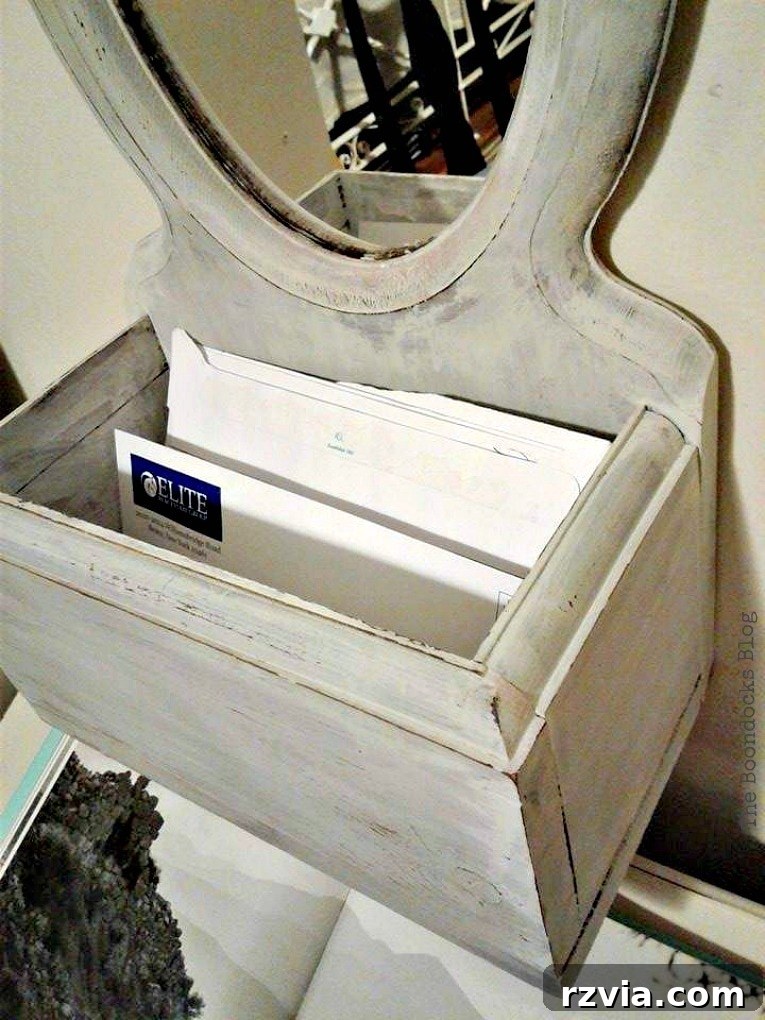 Storage box integrated into the mirror, painted in Oyster White Old Fashioned Milk Paint, matching room decor. theboondocksblog.com