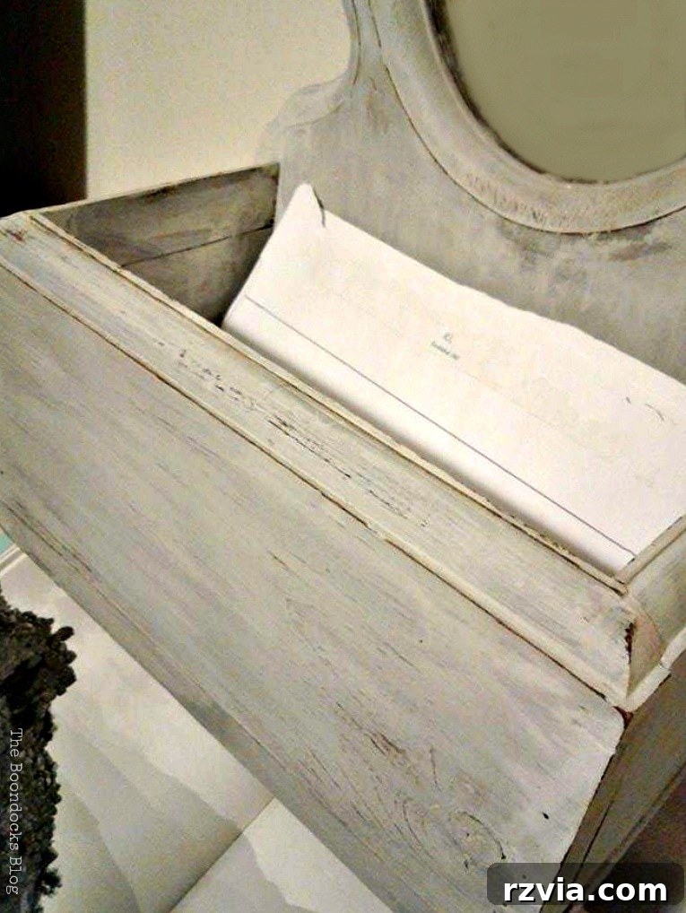 Detail shot of the mirror's integrated shelf, beautifully painted with Old Fashioned Milk Paint. theboondocksblog.com