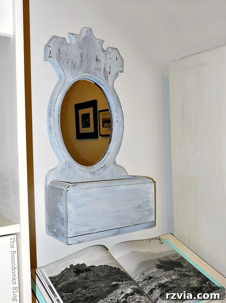 Finished mirror placed above the dictionary stand, flanked by upcycled bookcases. theboondocksblog.com