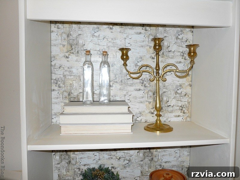 Paper and Paint Power: Bookcase Transformations 12 Shelf with candelabra, books and glass bottles.