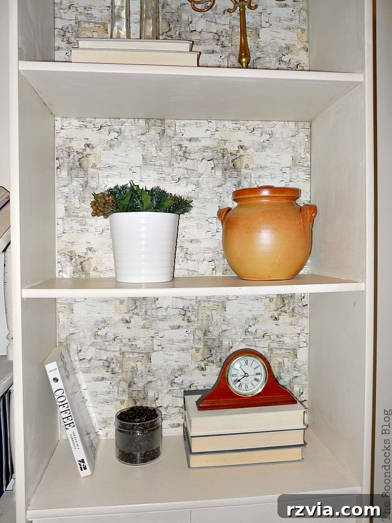 Paper and Paint Power: Bookcase Transformations 13 Close up of shelf decorated with clay pot, a plant, books and a clock.