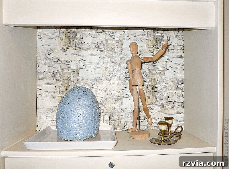 Paper and Paint Power: Bookcase Transformations 16 Decorative dragon egg, wooden doll and candles.