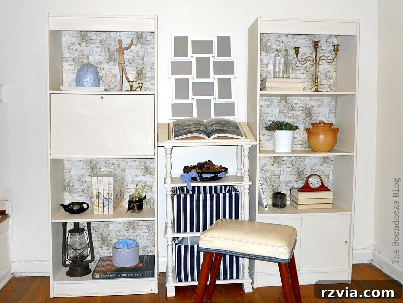 Paper and Paint Power: Bookcase Transformations 20 two bookcases with dictionary stand in the middle, Bookcases Upcycled with Paint and Wrapping Paper www.theboondocksblog.com