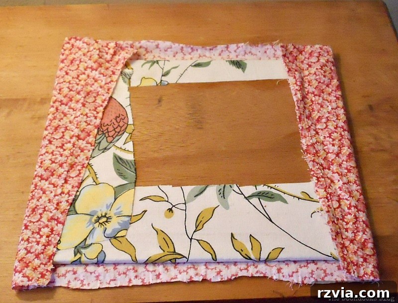DIY Valentine Heart Frame 8 Applying new red floral fabric over the existing decoupaged wood piece, inserted back into the frame