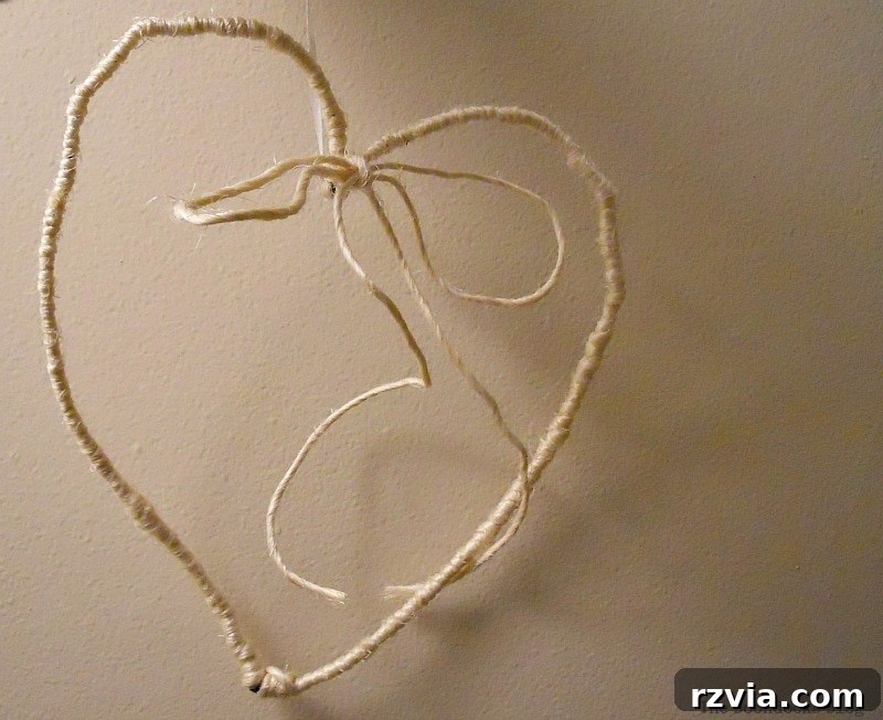 DIY Valentine Heart Frame 10 Wire heart completely wrapped in natural twine, with a small bow at the top