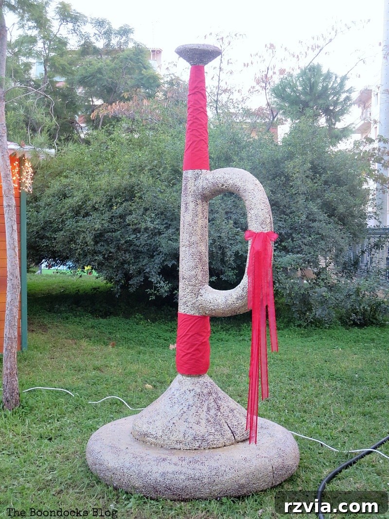 My Town's Best Kept Secrets 9 Giant, oversized trumpet decoration in a festive Christmas park