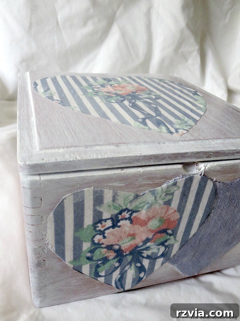 Front view of the wooden box with decoupaged hearts, showcasing the beautiful transformation