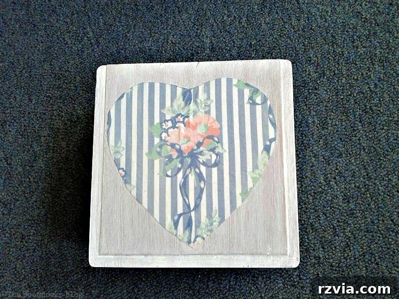 Decoupaged fabric heart on the top lid of the wooden gift box