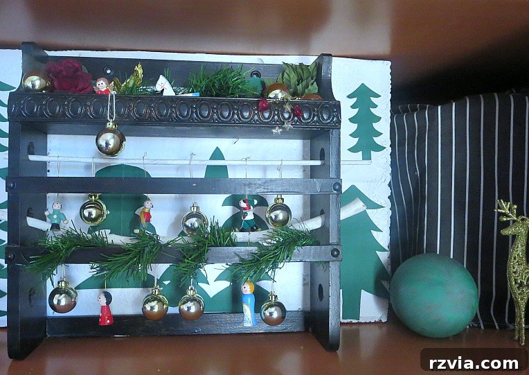 Old spice rack repurposed as a festive Christmas vignette on a shelf