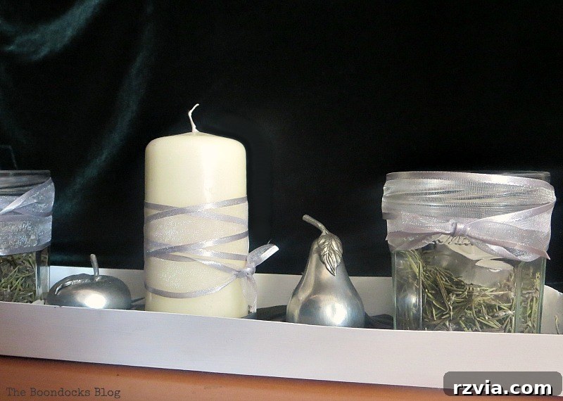 Green Christmas centerpiece with a repurposed chicken feeder base and velvet backdrop