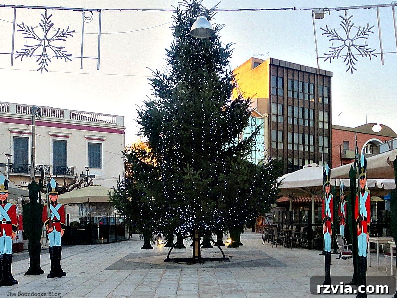 A large, festive Christmas tree illuminating a town square in Greece