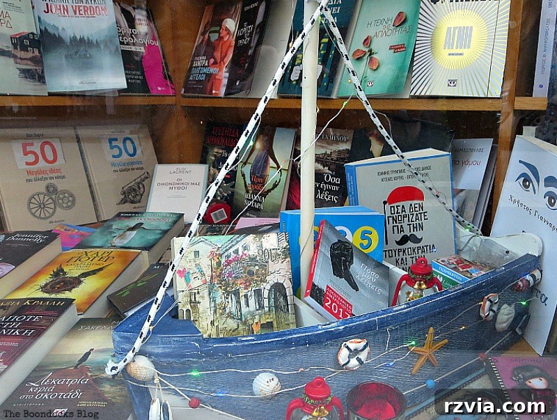 A charming decorated boat in a store window, showcasing traditional Greek Christmas decor