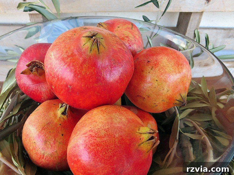 Autumn's Bounty for Your Table 7 Lustrous red pomegranates gathered in a clear glass bowl, ready to be placed within the centerpiece.