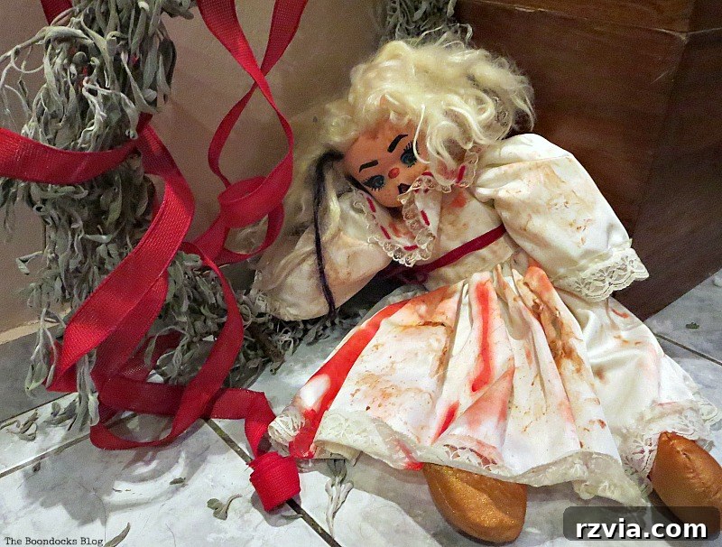 The hanging doll, after perhaps eating too many sweets, has fallen from her wreath, www.theboondocksblog.com