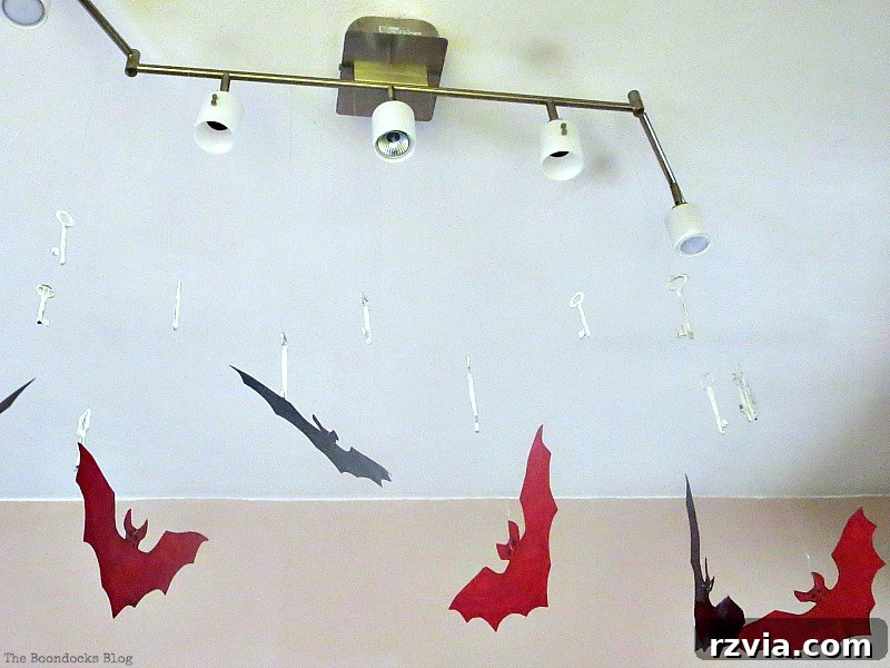 Decorative bats ominously hanging and descending from the ceiling, part of the Halloween decor at Paranoid Man's party, www.theboondocksblog.com