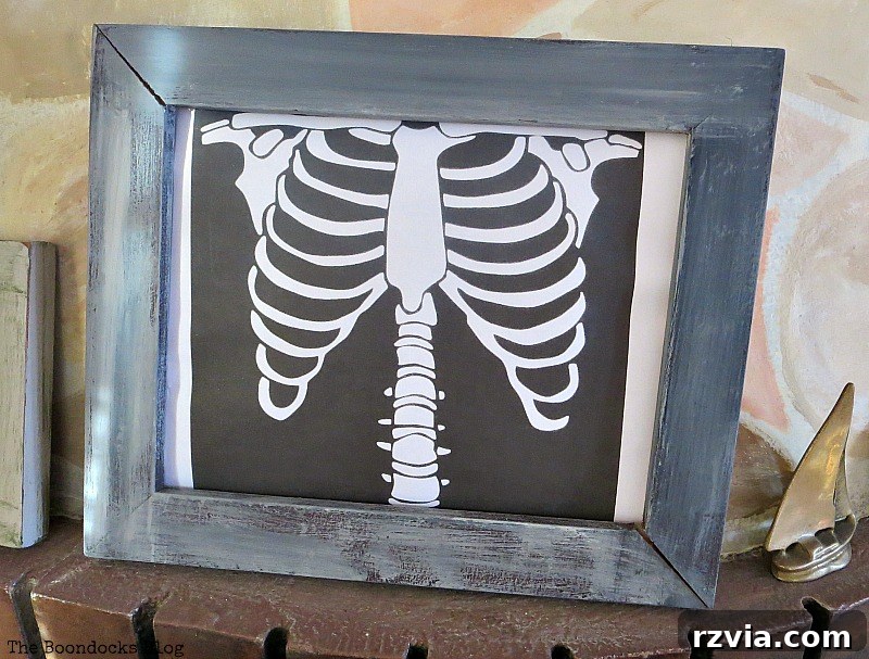 A decorative skeleton posed artfully on the mantel, transforming it into a spooky display for the Halloween party, www.theboondocksblog.com