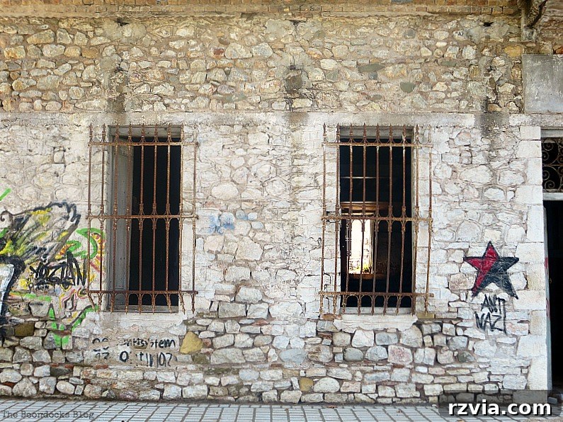 Stone Chronicles of the Shore 7 Historic stone building adorned with colorful graffiti, illustrating the intersection of ancient architecture and modern urban art on the waterfront. Image by www.theboondocksblog.com