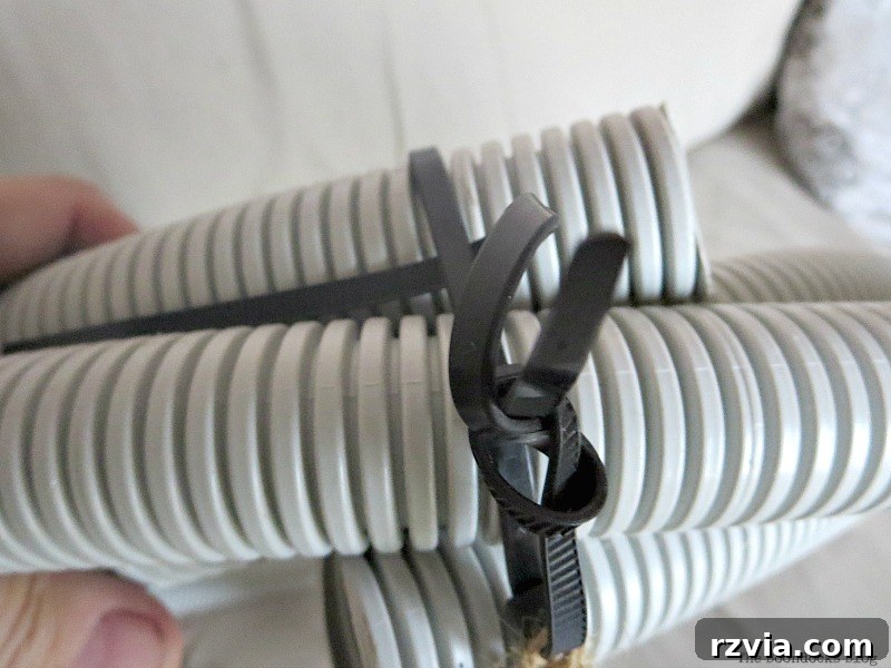 Transform Tubes into a Halloween Wreath 4 Close-up view of a plastic tube being secured into a wreath shape using strong cable ties.